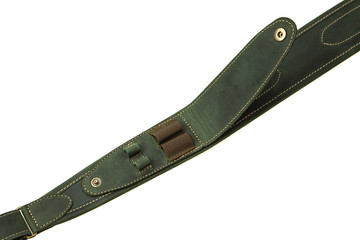 Green leather shoulder strap for a gun isolated on white background