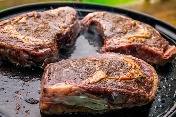 Grilled beef steak on the grill, close-up.