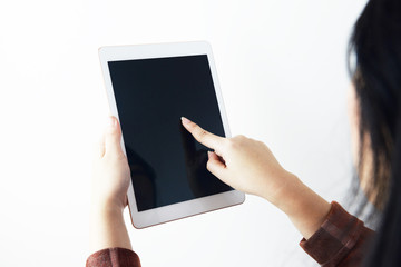 A woman is using tablet with white background isolated.