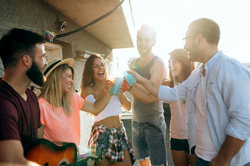 Group of carefree friends dancing have fun in summer