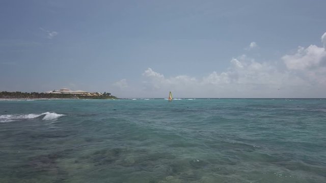 Riviera Maya, the Caribbean Sea in 4K.View on the surfboard, in the background the Barcelo Palace resort  near Tulum Mexico.