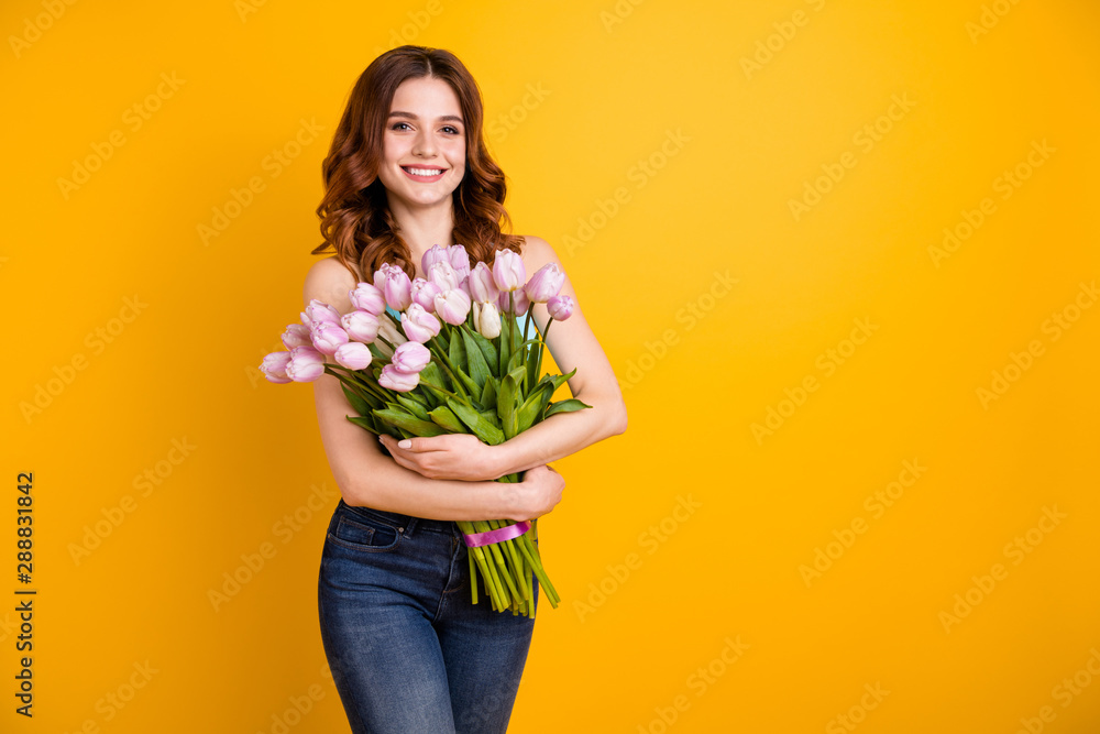 Sticker Spring freshness concept. Photo of amazing lady holding big bunch of pink tulips in hands wear tank-top isolated yellow background