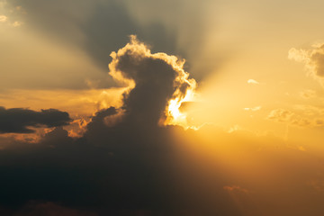 Sun behind clouds on a cloudy afternoon.