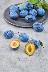 Raw organic plums in a on a vintage background