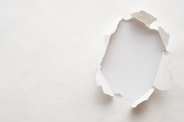 A hole in old paper with the sides torn off. with space for your message