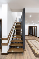 Wooden stairway in the house interior with stair light