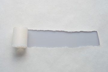 A long hole in old paper with place for your message. View from above