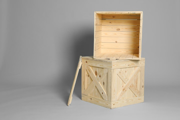 Wooden crates on grey background. Space for text