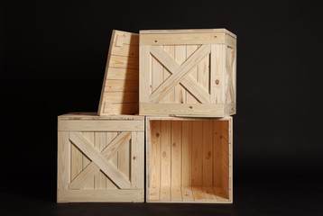 Group of wooden crates on black background