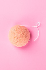 Natural, organic and biodegradable Konjac sponge, shot from the top on a pink background with copy space