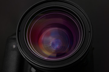 Lens of professional camera on black background, closeup