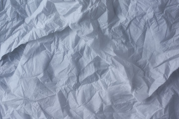 The crumpled background of the unfolded white paper