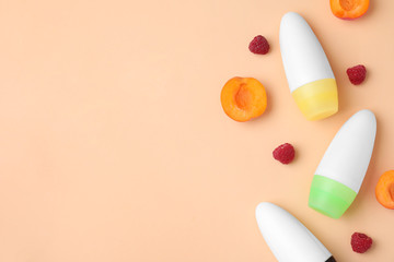 Flat lay composition with different female roll-on deodorants on beige background, space for text