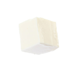 Piece of delicious feta cheese on white background