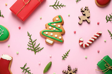 Flat lay composition with Christmas decorations on pink background