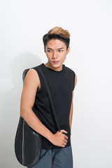 Fototapeta premium Asian badminton player with bag on white background