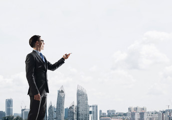 Concept of business success and control with confident boss against cityscape background