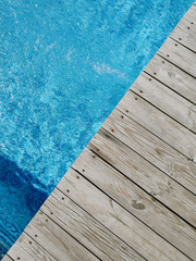 wooden platform on swimming pool background. top view. Procurement, a template for design with place for text. Old boards and a lake copy space.