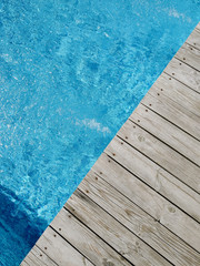wooden platform on swimming pool background. top view. Procurement, a template for design with place for text. Old boards and a lake copy space.