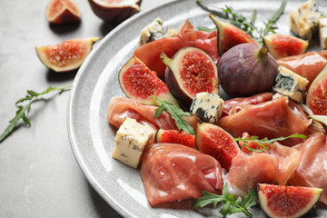 Plate with figs, prosciutto and cheese, closeup
