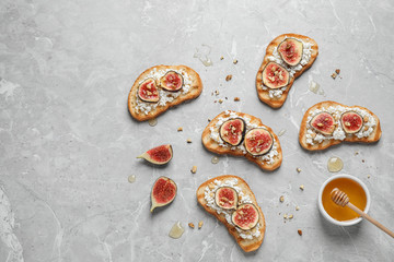 Bruschettas with cheese and figs on marble table, flat lay. Space for text