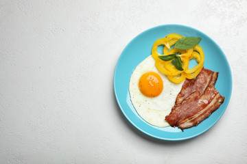 Breakfast with fried egg on white table, top view. Space for text