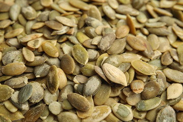 Raw peeled pumpkin seeds as background, closeup