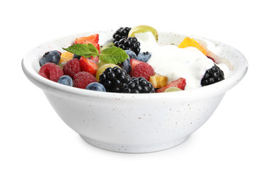 Fresh tasty fruit salad with yogurt on white background