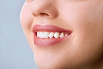 Closeup of smile with white healthy teeth.Teeth whitening. Dental care. Lips care