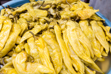 Pickled green hot peppers on the farmers market. Healthy vegan food.