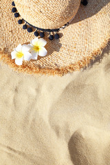 Fototapeta na wymiar Straw hat on sand, top view with space for text. Beach accessory
