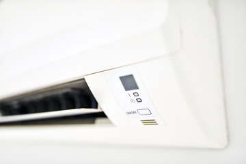 Moder air condition unit on a white wall inside the living room.