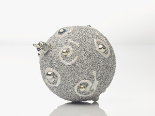 Silver christmas bauble on white