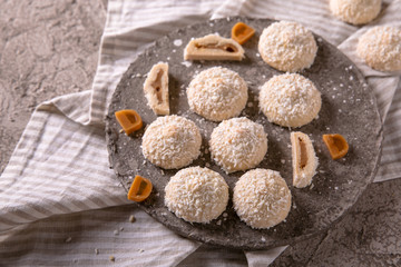 Obraz na płótnie Canvas Coconut biscuit with caramel. Crispy and crumbly delicious cookies with natural ingredients: flour, nuts, seeds, pieces of chocolate, cocoa, fruit jams.