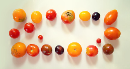Top view on natural fresh farm multi-colored tomatoes on the table.