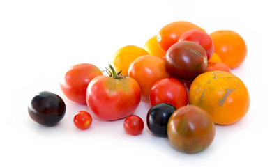 Natural fresh farm multi-colored tomatoes on a white background.