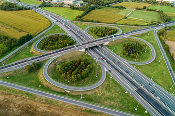 Cloverleaf interchange seen from above. Aerial view of highway road junction in the countryside....