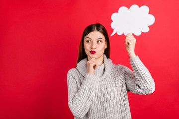 Funny lady with paper mind cloud in hand minded about dialogue answer wear knitted sweater isolated red background