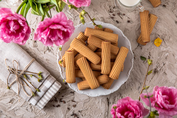 Fototapeta na wymiar Biscuit sticks with fruit filling. Crispy and crumbly delicious cookies with natural ingredients: flour, nuts, seeds, pieces of chocolate, cocoa, fruit jams. Spring Flower Still Life