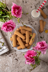 Biscuit sticks with fruit filling. Crispy and crumbly delicious cookies with natural ingredients: flour, nuts, seeds, pieces of chocolate, cocoa, fruit jams. Spring Flower Still Life