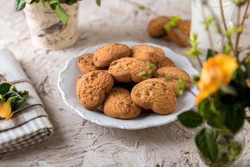 Biscuit hearts. Crispy and crumbly delicious cookies with natural ingredients: flour, nuts, seeds, pieces of chocolate, cocoa, fruit jams. Spring flower still life