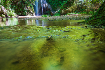 Waterfall surrounded by greenery. Acquacaduta. Friuli, Italy