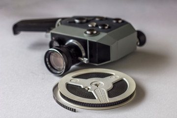 film reel on blurry background of a vintage mechanical video camera