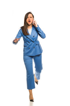 Young Business Woman Running And Talking On The Phone On A White Background