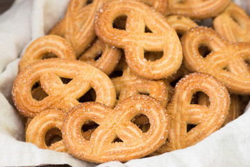 Cookies with sugar in a basket on a wooden table