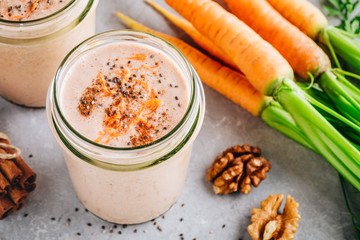 Healthy carrot cake smoothie with walnuts and chia seeds in glass jars