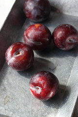 plum fruits in a metal tray