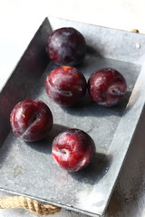 plum fruits in a metal tray