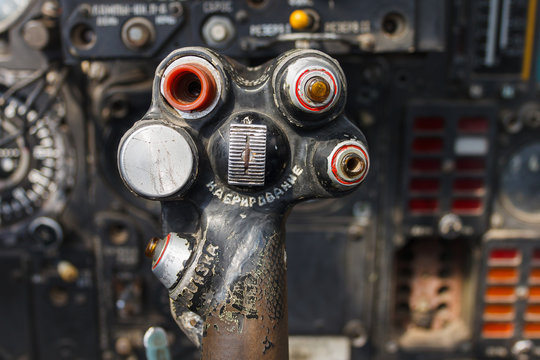 Military aircraft control knob. In the cockpit of an old, Soviet military jet. Close-up. Text translation from Russian "pitching nose up"