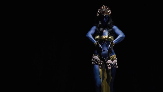 Indian goddess Kali is dancing with the blades on black background